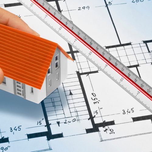 BUILDING PERMIT DOCUMENT WITH ARCHITECTURAL BLUEPRINT of an old residential building - Concept of construction, real estate development, and planning approval
